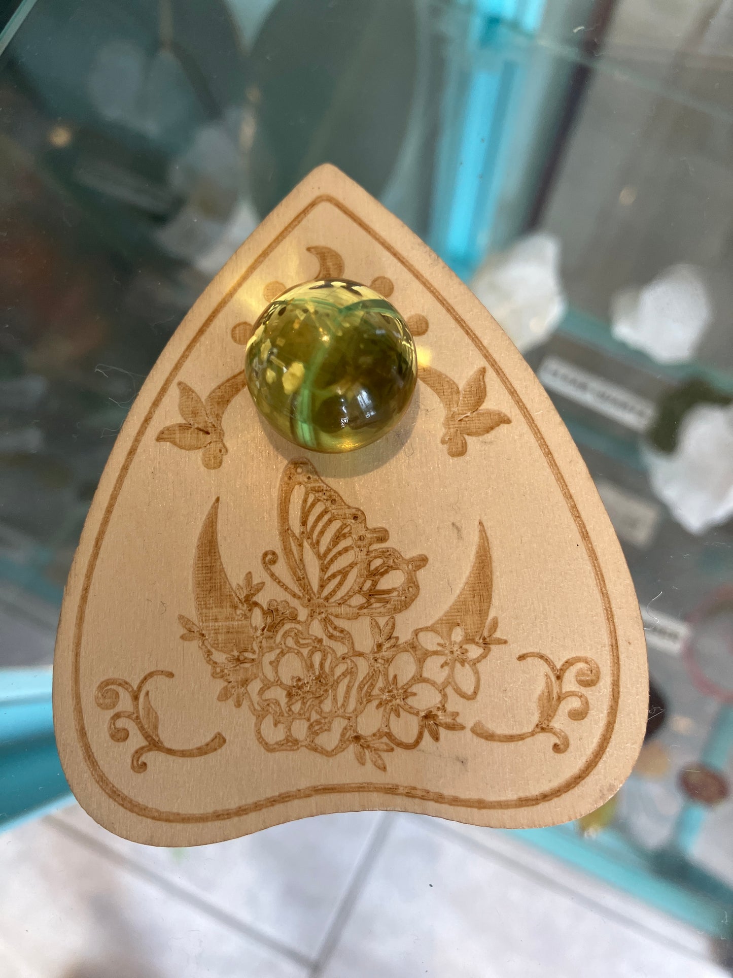 Yellow Glass Sphere on Decorative Wood Display